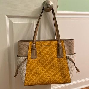 Michael Kors yellow and beige shoulder bag.